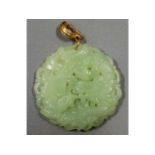 A Chinese carved jade pendant, 49mm diameter, 33.9