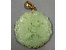 A Chinese carved jade pendant, 49mm diameter, 33.9