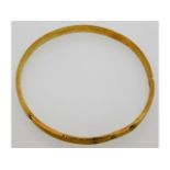 An antique 9ct gold bangle, internal diameter 76mm