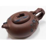 A Chinese Yixing teapot, 5.625in wide, four charac