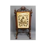 A large 19thC. rosewood ornate firescreen with rai