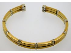 An 18ct two colour gold flexi bangle, internal mea