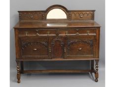 An early 20thC. oak sideboard with barley twist le