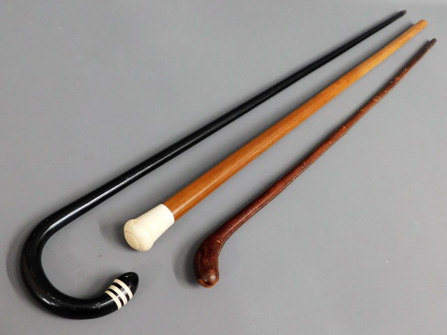 An ivory topped Malacca cane & two others, longest