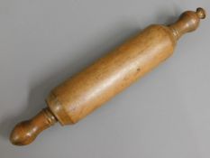 An early 20thC. wooden rolling pin