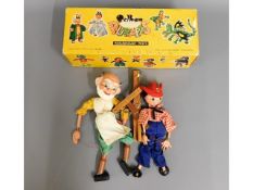 Two Pelham puppets, tangled, with one box