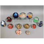 A quantity of 13 glass paper weights including