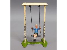 A diecast child on swing, probably Britains