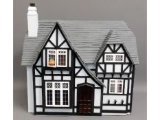 A Tudor style dolls house, open back with electric