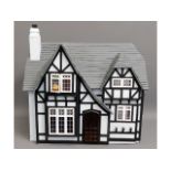 A Tudor style dolls house, open back with electric