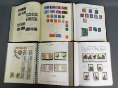 Four British stamp albums including Victorian & QEII mint, face value of mint £36.25