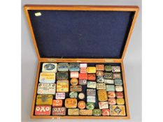 An oak cased collection of gramophone needle tins