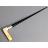 A ivory topped ebonised cane with silver collar, 3
