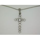 An 18ct white gold necklace with cross set with ap