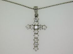 An 18ct white gold necklace with cross set with ap