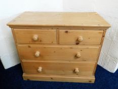 A low level pine chest with four drawers, 33.75in