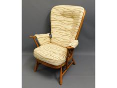 An upholstered blond Ercol chair with original lab