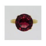 A 14ct gold ring set with ruby coloured paste ston