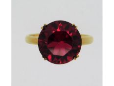 A 14ct gold ring set with ruby coloured paste ston