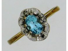 A 9ct gold topaz ring with four illusion set diamo