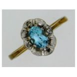 A 9ct gold topaz ring with four illusion set diamo