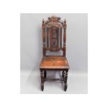 A c.1900 carved oak high backed hall chair, 44.5in