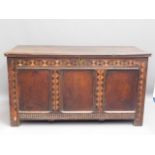 An 18thC. inlaid oak coffer, 50in wide x 27in high