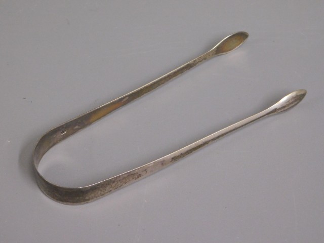 A pair of Georgian 1812 London silver tongs by Pet