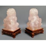 A pair of Tibetan carved pink quartz foo dogs with