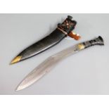 A kukri knife with leather scabbard, 17.125in long