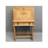 A 1920's ladies oak bureau with barley twist legs,