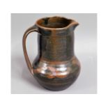 A Bernard Leach style studio pottery jug, some nib