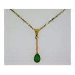 An antique style yellow metal pendant with 28mm drop, tests electronically as 18ct gold, set with di