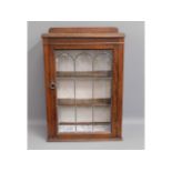 An early 20thC. oak wall cabinet with shelves, 33i