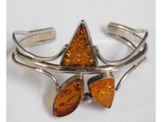 A silver bangle set with amber, 32.8g