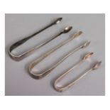 Three pairs of silver tongs including James Deakin