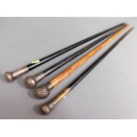 Four silver topped walking canes, few bumps, one b