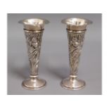 A pair of decorative lead loaded silver posy vases