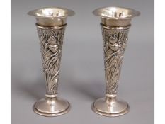 A pair of decorative lead loaded silver posy vases