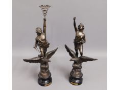 A pair of French spelter figures titled "Commerce