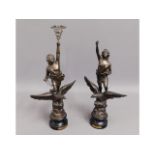 A pair of French spelter figures titled "Commerce