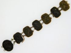 A 19thC. carved volcanic rock cameo part bracelet