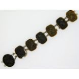 A 19thC. carved volcanic rock cameo part bracelet