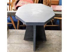 A heavy octagonal cut slate garden table, 17in hig