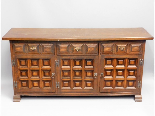 A 20thC. oak sideboard with three cupboards & thre