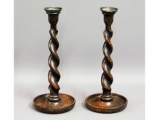 A pair of Victorian barley twist oak candlesticks,