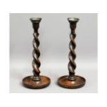 A pair of Victorian barley twist oak candlesticks,