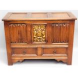 An oak blanket box with linenfold & coat of arms d
