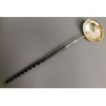 An 18/19thC. baleen & white metal toddy, tests as silver, 13in long, 41.1g
