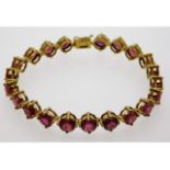 A 9ct gold bracelet set with twenty one Madagascan